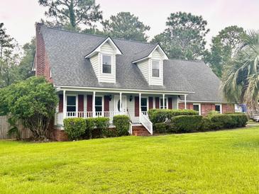 Charming home with a covered porch, dormer windows, and well-maintained landscaping at 101 Limerick Cir, Summerville, SC 29483