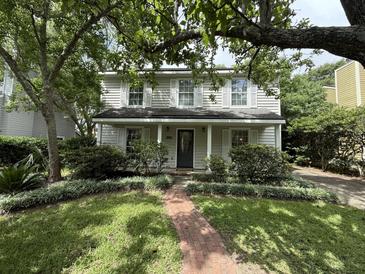 Charming two-story home with a brick walkway and well-manicured landscaping at 1433 Oaklanding Rd, Mount Pleasant, SC 29464
