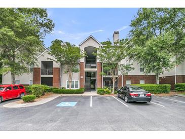 Attractive apartment building with staircase, manicured landscaping, and convenient parking at 2011 N Hwy 17 # 2200H, Mount Pleasant, SC 29466