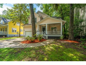 Charming home featuring a lovely front porch, well-maintained lawn, and an attached garage at 3005 Macbeth Creek Dr, Charleston, SC 29414