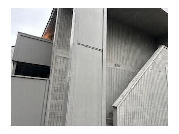View of the building's exterior siding, steps, and the number '806' displayed above the staircase at 806 Greenmeadow Dr, Goose Creek, SC 29445