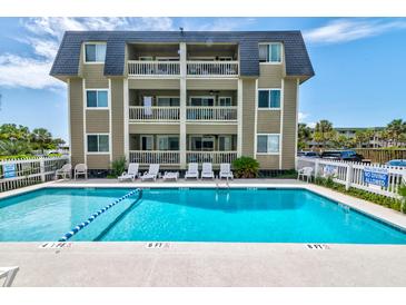 Beautiful condominium complex featuring a large shimmering pool with ample space for sunbathing and relaxation at 1400 Ocean Blvd # 106B, Isle of Palms, SC 29451