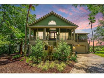 Charming two-story home with a landscaped front yard and inviting front porch at 1520 Regimental Ln, Johns Island, SC 29455