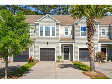Charming townhouse with well-maintained lawn, gray siding, and black garage doors at 2505 Stadium Dr, North Charleston, SC 29406
