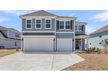 Two-story home with a three-car garage and a well-maintained front yard at 2807 Grange Cir, Summerville, SC 29486