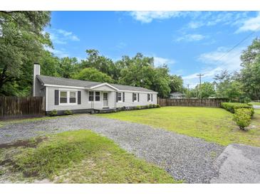 Charming single story home with grey siding, black shutters and well maintained front lawn at 3284 Sassy Dr, Johns Island, SC 29455