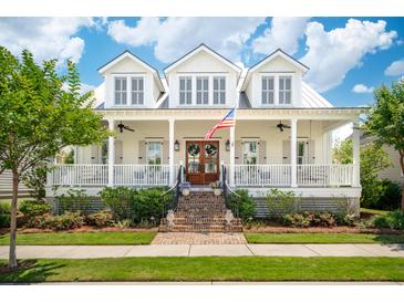 Charming two-story home with a brick staircase and a welcoming front porch beneath a bright blue, partly cloudy sky at 371 Bridgetown Pass, Mount Pleasant, SC 29464