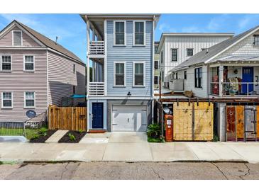 Charming two-story home with a blue exterior, a garage, and a small landscaped front yard at 4 Line St, Charleston, SC 29403