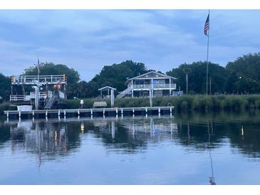 Charming waterfront property features a private dock and stunning views of the water at 4352 Bream Rd Rd, North Charleston, SC 29418