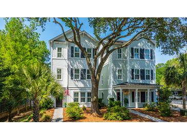 Charming two-story home with a landscaped yard and a welcoming front porch, great for relaxing and enjoying the neighborhood at 977 Warrick Oaks Ln, Mount Pleasant, SC 29464