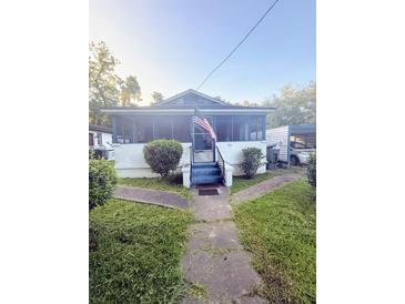 Charming single story home with screened in porch and lush green front lawn at 1124 Davidson Ave, Charleston, SC 29407