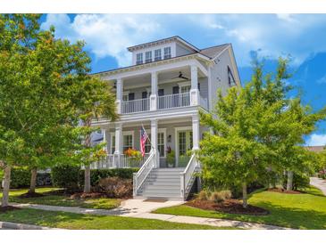 Beautiful two-story home featuring double porches and a welcoming entrance with manicured landscaping at 1530 Willtown St, Daniel Island, SC 29492