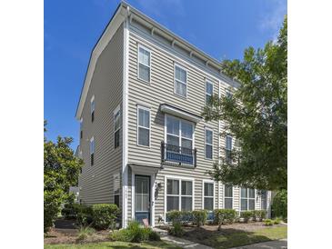 Charming townhome featuring neutral siding, a small balcony, and well-maintained landscaping at 1543 Bluewater Way, Charleston, SC 29414