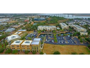 Scenic aerial view of building exteriors, parking, waterways and bridges in a coastal community at 225 Seven Farms Dr # 307, Daniel Island, SC 29492