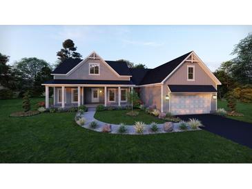 Charming two-story home with a covered porch, manicured lawn, lush landscaping, and a two car garage at 4848 Woodville Rd, Awendaw, SC 29429