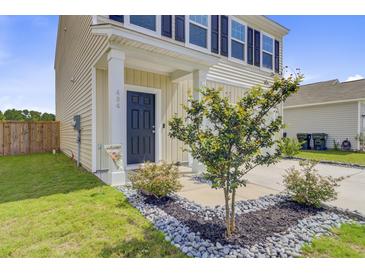 Inviting home entrance featuring a navy front door, manicured landscaping, and a welcoming aesthetic at 494 Pender Woods Dr, Summerville, SC 29486