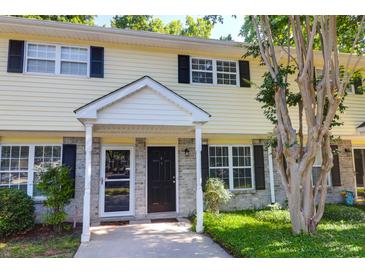 Charming townhome with a well-maintained lawn, brick facade, black shutters, and inviting entranceway at 507 Stinson Dr # 4G, Charleston, SC 29407