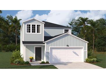 Charming two-story home featuring light blue siding, a black roof, and an attached white single-car garage at 529 Blue Mistflower Dr, Moncks Corner, SC 29461
