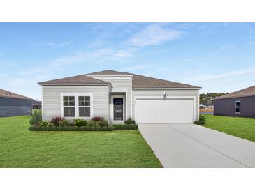 Charming single-story home with a well-manicured lawn and a two-car garage at 549 Blue Mistflower Dr, Moncks Corner, SC 29461