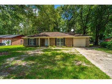 Charming brick home with a well-manicured front yard and mature trees at 610 Old Golf Rd, Summerville, SC 29483