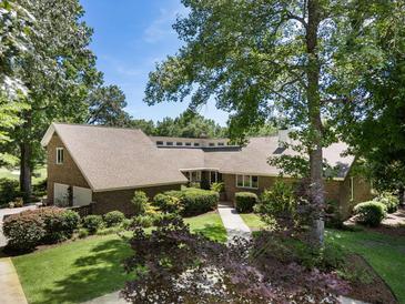 Charming single-story brick home with lush landscaping and mature trees, providing a serene and inviting curb appeal at 914 Red Coat Run, Mount Pleasant, SC 29464