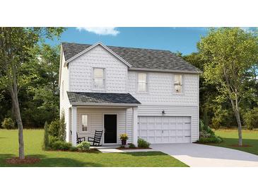 Charming two-story home featuring a covered porch, attached garage, and beautiful landscaping at 113 Pen Shell St, Summerville, SC 29485