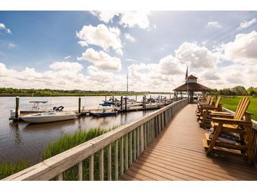Scenic marina view with boardwalk, gazebo and multiple boats docked on the water at 2329 Tall Sail Dr # 704D, Charleston, SC 29414