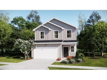 Charming two-story home featuring a white garage door, and beautifully landscaped front yard at 620 Culpepper St, Summerville, SC 29486