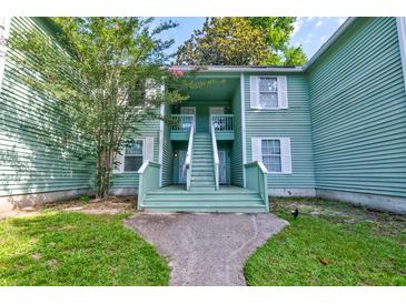 Inviting exterior view of the home featuring a charming entryway and well-maintained lawn at 6280 Rolling Fork Rd # 302, North Charleston, SC 29406