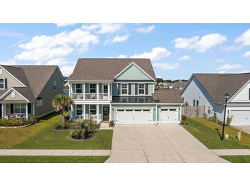 Inviting two-story home with a charming front porch, landscaped lawn and a two car garage at 658 Yellow Leaf Ln, Summerville, SC 29486