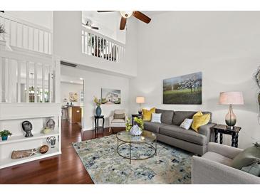 Bright living room with high ceilings, wood floors, and elegant decor at 105 Brockman Way, Goose Creek, SC 29445