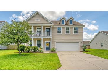 Charming two-story home featuring a welcoming front porch, attached two-car garage, and well-manicured lawn at 109 Cypress Plantation Rd, Moncks Corner, SC 29461