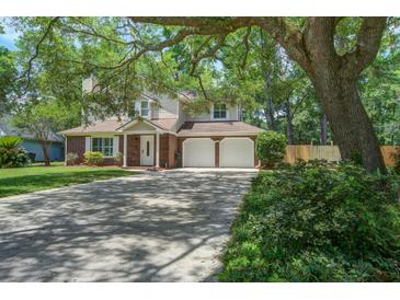 Charming two-story home boasts a brick facade, a two-car garage and a large, mature shade tree at 110 Bayberry Run, Summerville, SC 29485
