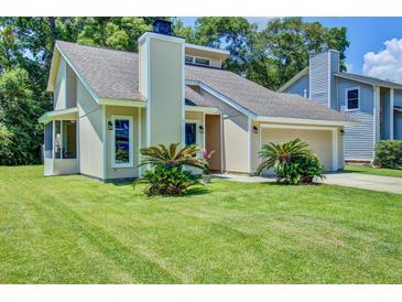 Charming single-Gathering home features a manicured lawn and attached two-car garage at 112 Lewisfield Dr, North Charleston, SC 29418