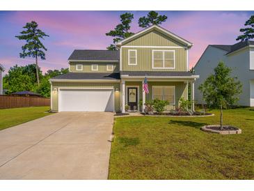 Charming two-story home with a well-manicured lawn, inviting curb appeal, and an attached two-car garage at 119 Lucca Dr, Summerville, SC 29486