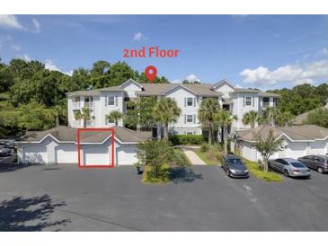 Condominium exterior showing a view of second story units with garage parking on the ground level at 1300 Park West Blvd # 106, Mount Pleasant, SC 29466