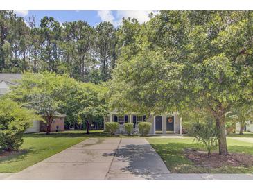 Charming single Gathering home with a well maintained front yard, mature trees, and a long driveway at 2136 Kings Gate Ln, Mount Pleasant, SC 29466