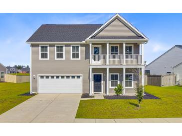 Charming two-story home with a welcoming front porch and a two-car garage, nestled in a serene neighborhood at 240 Lucca Dr, Summerville, SC 29486