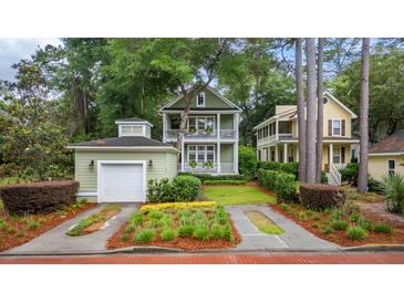 Charming two-story home with a garage, landscaped yard, and inviting double porches at 3221 Johnstowne St, Johns Island, SC 29455