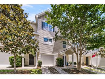 Charming townhome with a well-maintained lawn, inviting entrance, and attached one car garage at 4060 Hartland St, Charleston, SC 29414