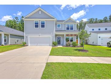 Charming two-story home featuring a well-manicured lawn and attached garage, perfect for suburban living at 4314 Cotton Flat Rd, Summerville, SC 29485
