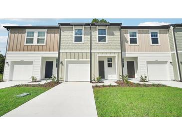 New townhomes feature a classic design with attached garages and professionally landscaped yards at 493 Colchester Court Ct, Moncks Corner, SC 29461