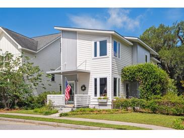 Charming two-story home with a modern design, landscaped yard, and inviting front porch perfect for enjoying the outdoors at 5017 W Liberty Park Cir, North Charleston, SC 29405