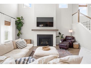 Comfortable living room with a fireplace, plush sofa, and staircase at 102 Bolsena Ct, Summerville, SC 29486