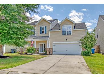 Charming two-story home with a well-manicured lawn, a two-car garage, and inviting curb appeal at 1052 Whitlow Blvd, Summerville, SC 29483
