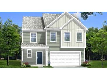 Charming two-story home with a welcoming front porch and a two-car garage nestled on a well-manicured lawn at 111 Cadbury Loop, Summerville, SC 29486
