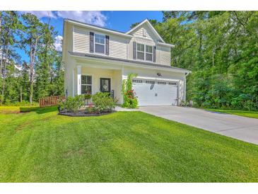 Charming two-story home with a well-maintained lawn and attached two-car garage at 115 Cooper Dr, Summerville, SC 29483