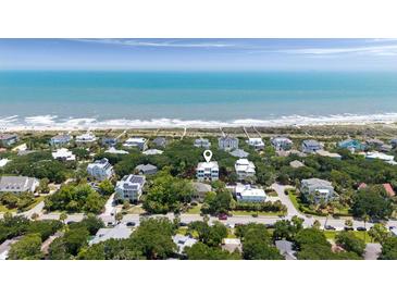 Beautiful oceanfront home nestled amongst lush greenery with direct beach access at 14 55Th Ave, Isle of Palms, SC 29451