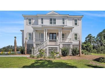 Charming two-story home featuring a welcoming front porch and classic architectural details at 1491 Tomato Farm Cir, Mount Pleasant, SC 29464