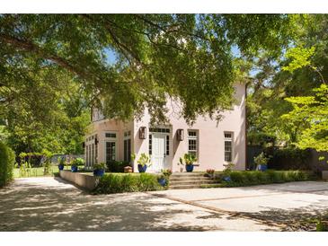 Stately home features a stucco exterior, mature trees, manicured landscaping, and a spacious driveway at 429 Venning St, Mount Pleasant, SC 29464